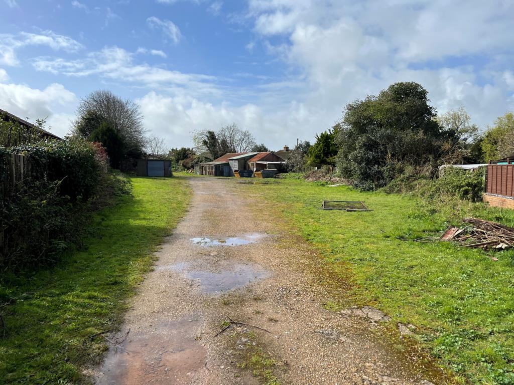 Lot: 114 - THREE-QUARTER ACRE FORMER COUNCIL DEPOT SITE WITH PLANNING FOR FIVE HOUSES - The site from Victoria Crescent end